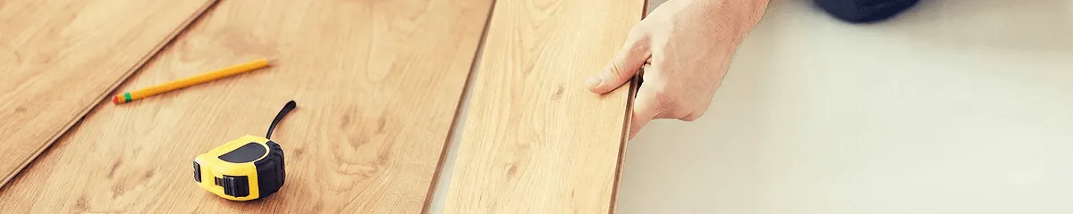 A professional installing wood flooring in Evansville, IN