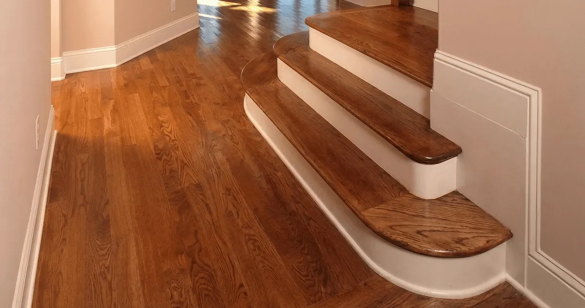 Base floor of a staircase with professionally restored wood flooring in Evansville IN