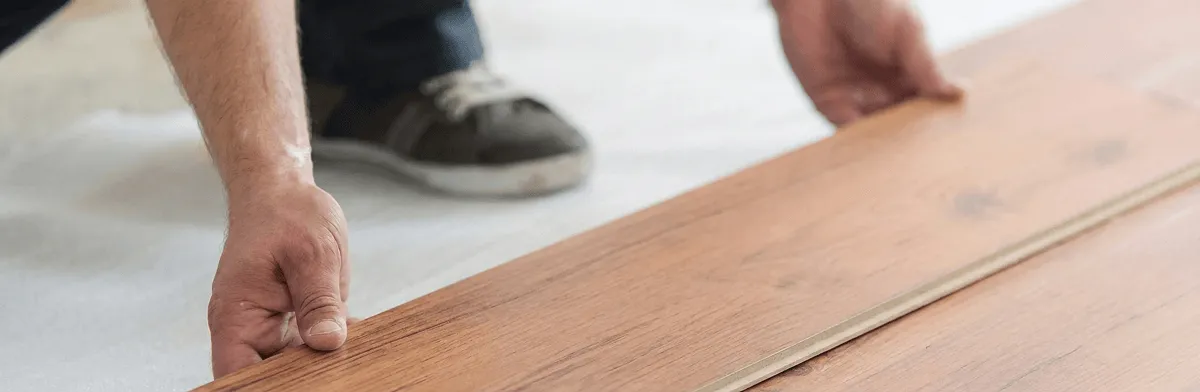 A professional installing laminate flooring in Evansville, IN