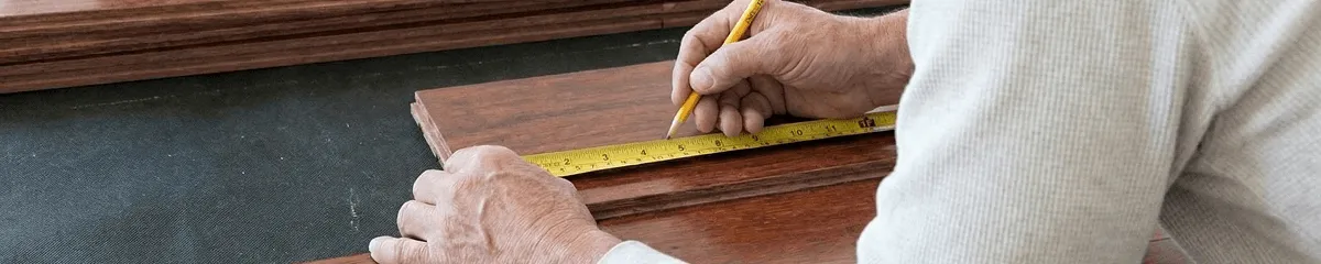 A professional installing wood flooring in Evansville, IN
